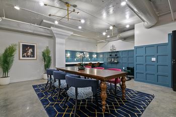 Conference room with blue wainscoting and wood dining table